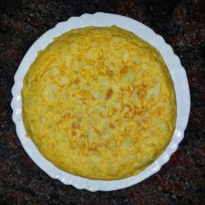 Frittata alta e soffice su un piatto, pronta per essere servita.